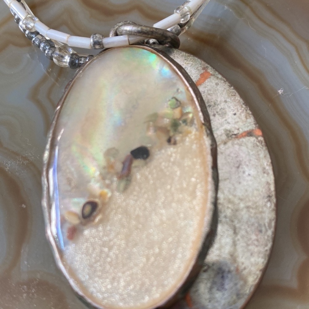 Three strand beaded necklace with shell